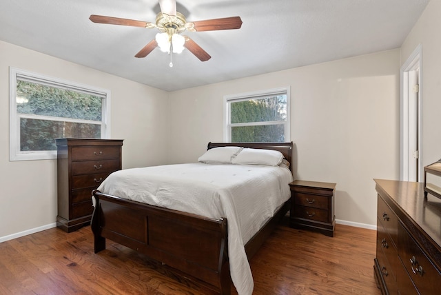 bedroom with dark hardwood / wood-style floors and ceiling fan