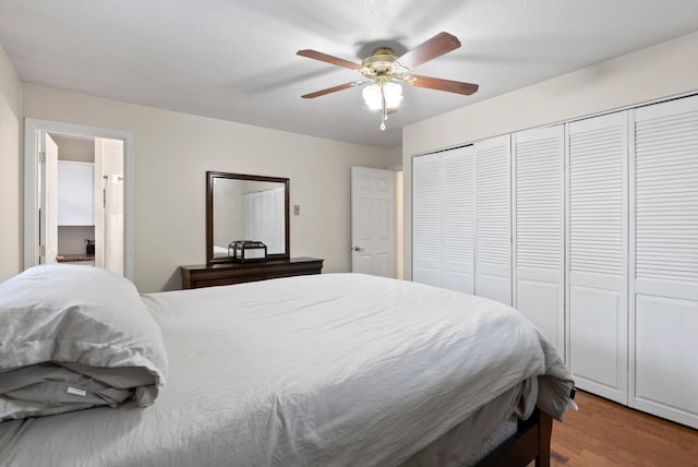 bedroom with hardwood / wood-style flooring, ceiling fan, and a closet