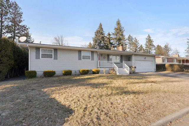 ranch-style home with a garage, a front yard, and covered porch