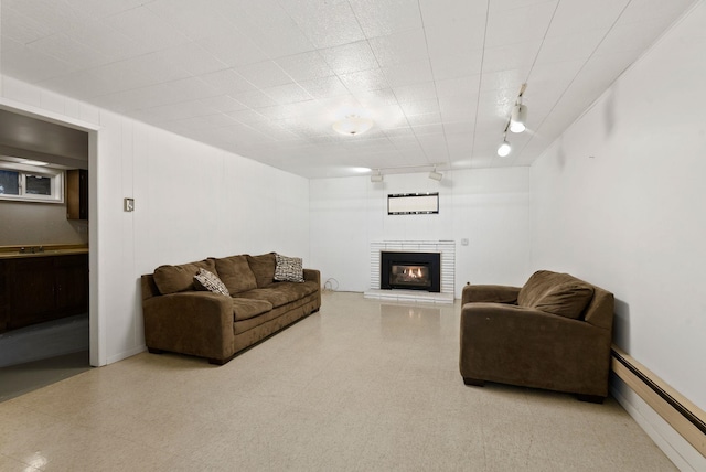 living room with track lighting and baseboard heating