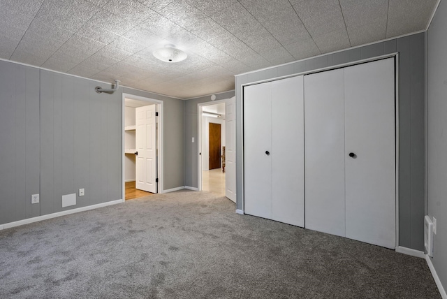 unfurnished bedroom with light carpet and a closet