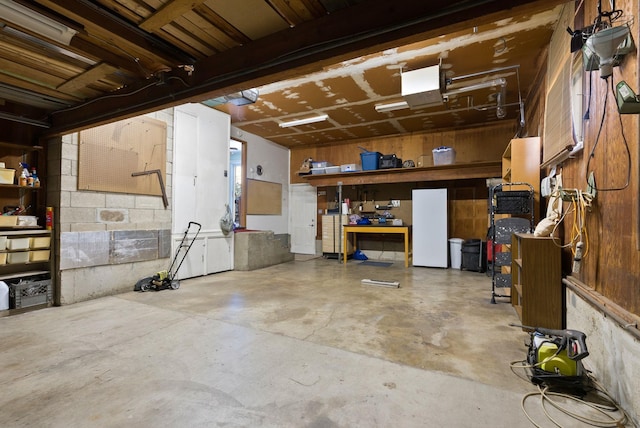 garage featuring a garage door opener and a workshop area