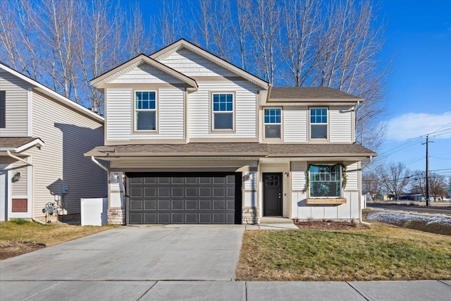 view of front of property featuring a garage and a front yard