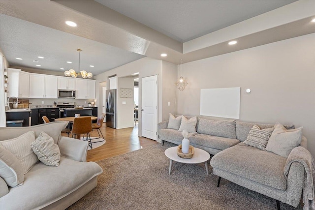 living room with sink and light wood-type flooring