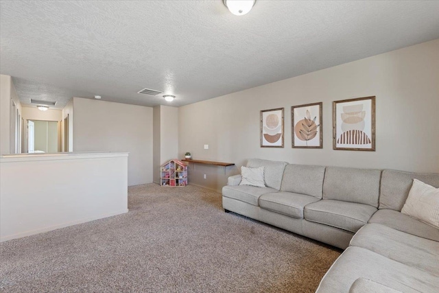 carpeted living room featuring a textured ceiling