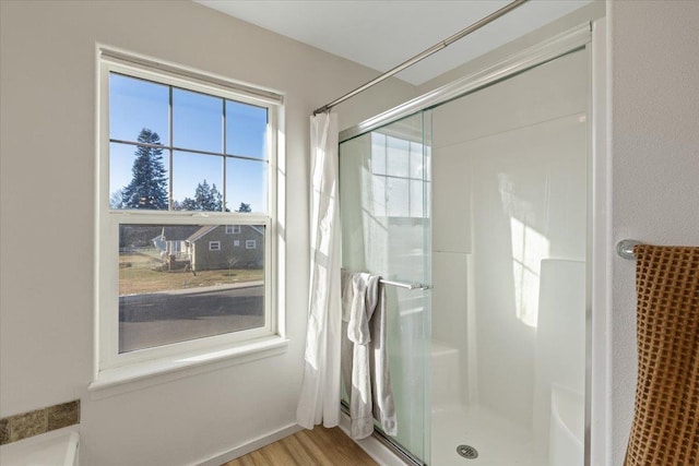 bathroom featuring hardwood / wood-style floors and walk in shower