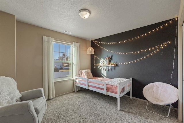 carpeted bedroom with a textured ceiling