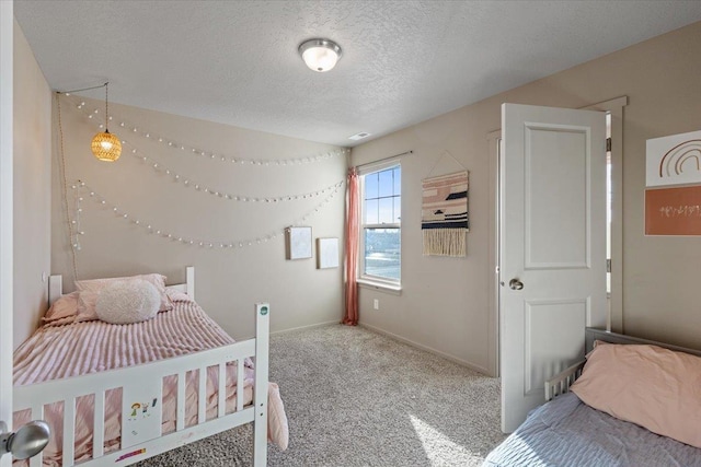 bedroom featuring carpet floors and a textured ceiling