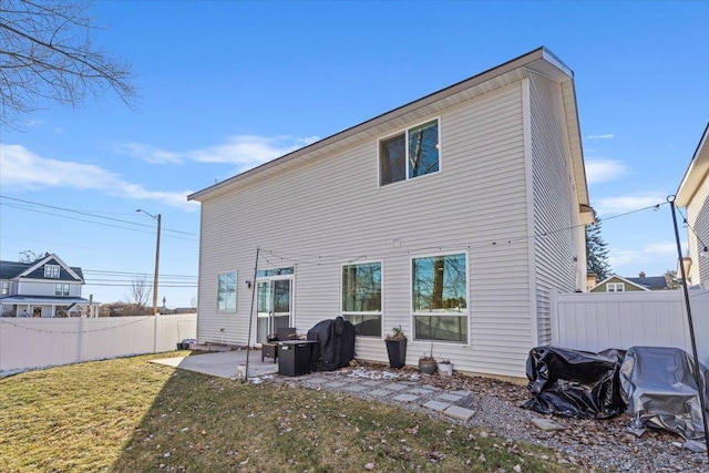 rear view of property with a patio area and a lawn