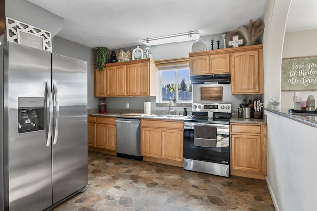 kitchen featuring sink, light stone countertops, and appliances with stainless steel finishes