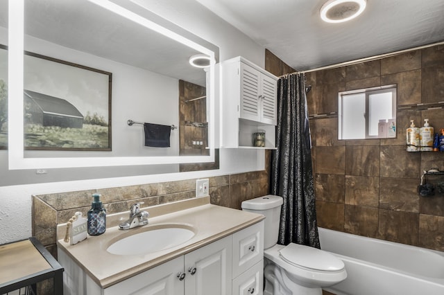 full bathroom with vanity, tile walls, shower / tub combo, and toilet