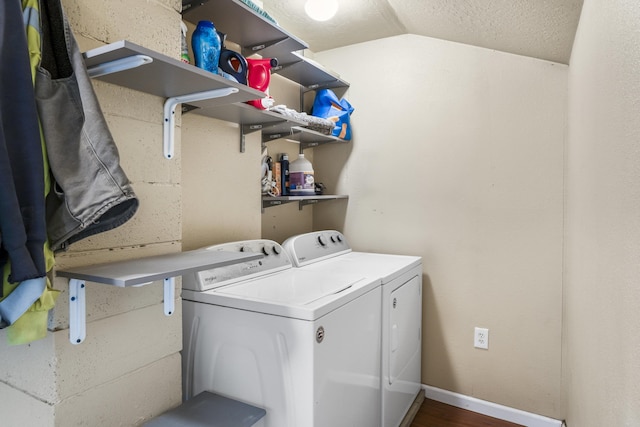 laundry room with hardwood / wood-style flooring and washing machine and dryer