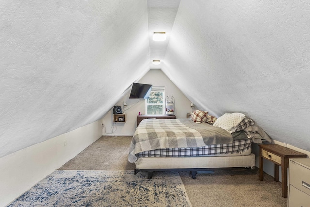 bedroom with lofted ceiling, carpet floors, and a textured ceiling