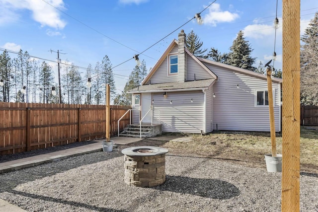 rear view of house with a fire pit