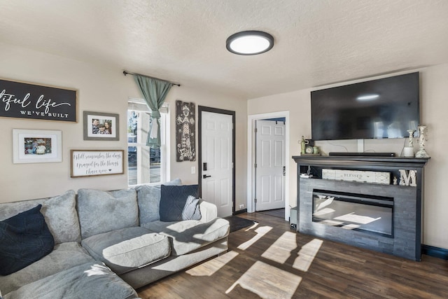 living room with dark hardwood / wood-style flooring and a textured ceiling