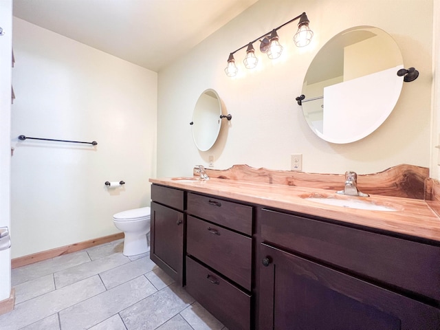 bathroom with vanity, tile patterned floors, and toilet