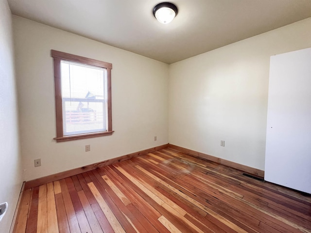 unfurnished room with wood-type flooring