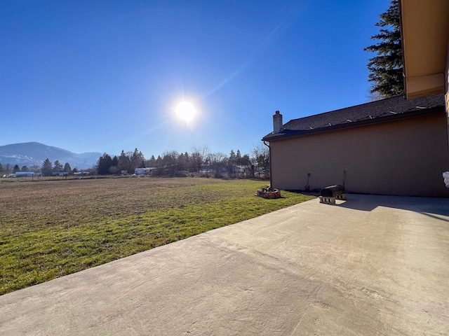 view of patio / terrace featuring a mountain view