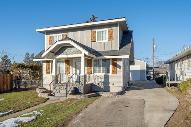 view of front of house with a garage, an outdoor structure, and a front yard