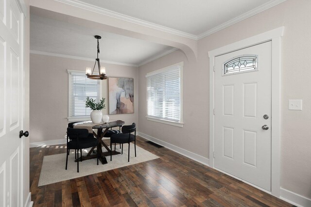 living room with crown molding, a stone fireplace, and dark hardwood / wood-style floors