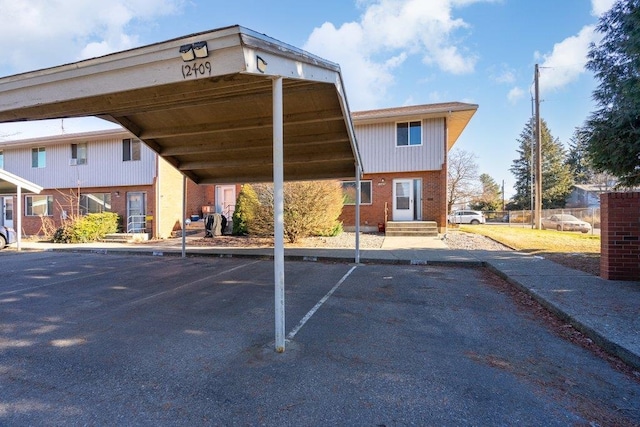 view of parking / parking lot featuring a carport