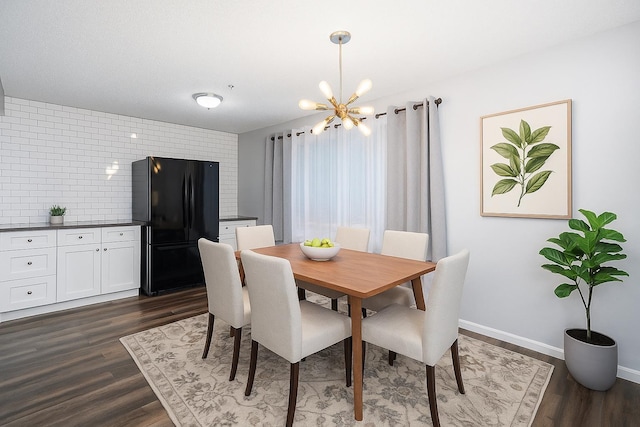 12409 E Olive Ave, Spokane Valley, WA 99216 - dining room featuring a chandelier, dark wood-type flooring, and baseboards