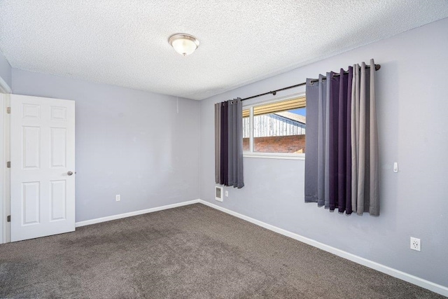 12409 E Olive Ave, Spokane Valley, WA 99216 - empty room with dark colored carpet, a textured ceiling, and baseboards