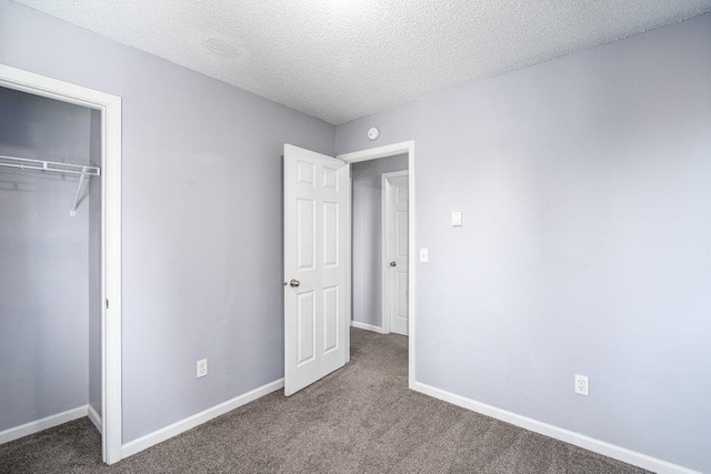 unfurnished bedroom with a closet, a textured ceiling, and carpet flooring