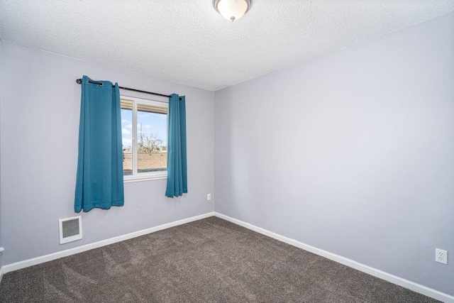 empty room featuring carpet and a textured ceiling