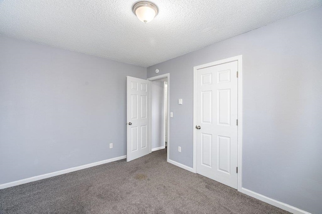 unfurnished bedroom featuring carpet floors and a textured ceiling