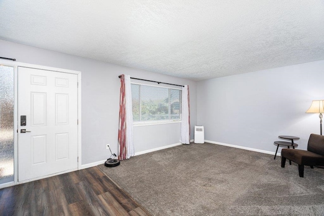 interior space with dark hardwood / wood-style flooring and a textured ceiling