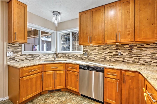 kitchen with sink, decorative backsplash, light stone countertops, and dishwasher