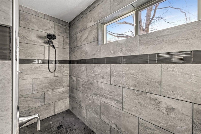 bathroom with tiled shower