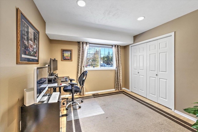 office featuring hardwood / wood-style flooring and a textured ceiling