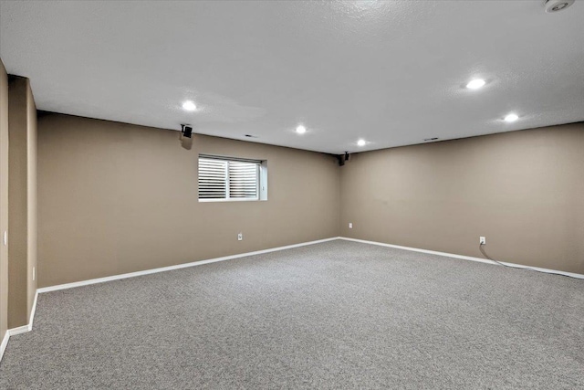 unfurnished room featuring carpet floors and a textured ceiling