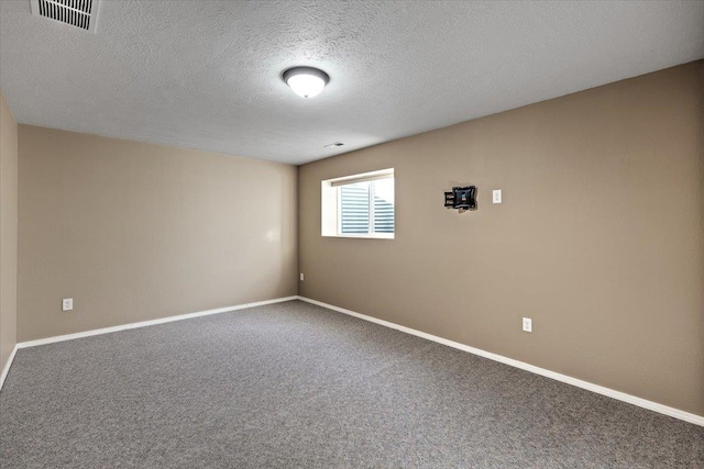 carpeted spare room featuring a textured ceiling