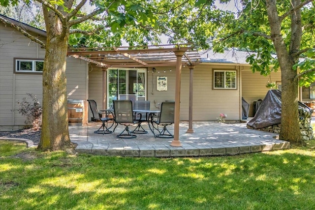 rear view of house featuring a pergola, a lawn, and a patio area