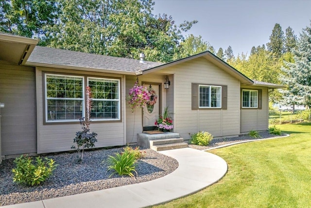 ranch-style home with a front lawn