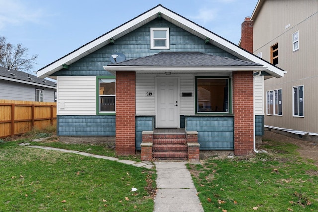 bungalow-style home featuring a front lawn