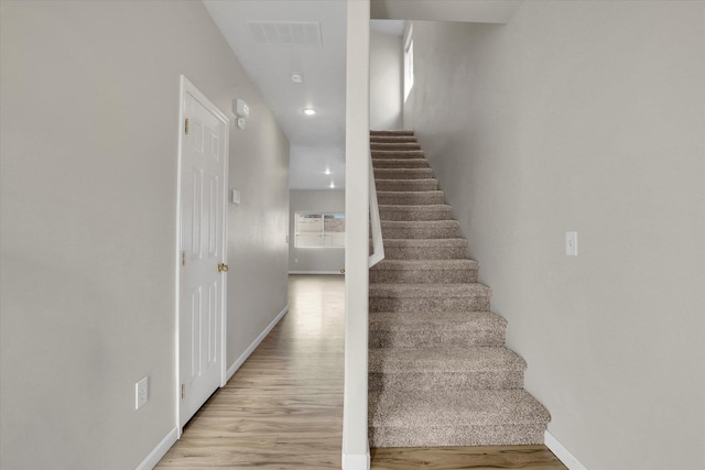 stairway featuring hardwood / wood-style flooring