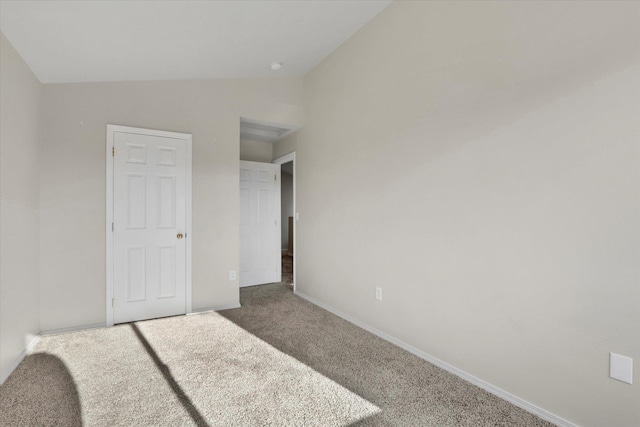 carpeted bedroom featuring lofted ceiling