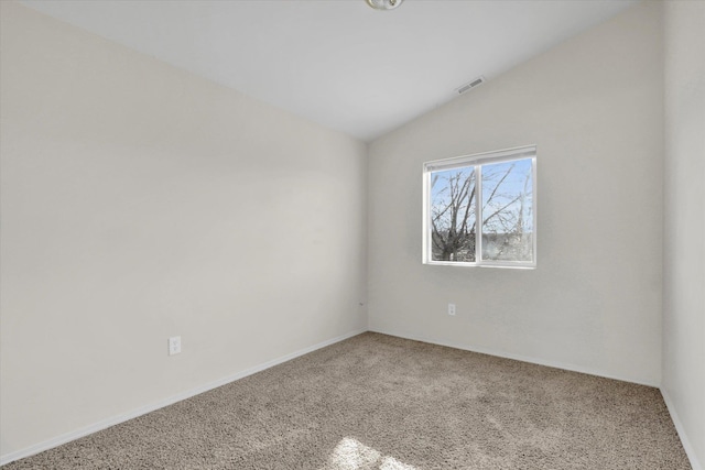 carpeted empty room with lofted ceiling