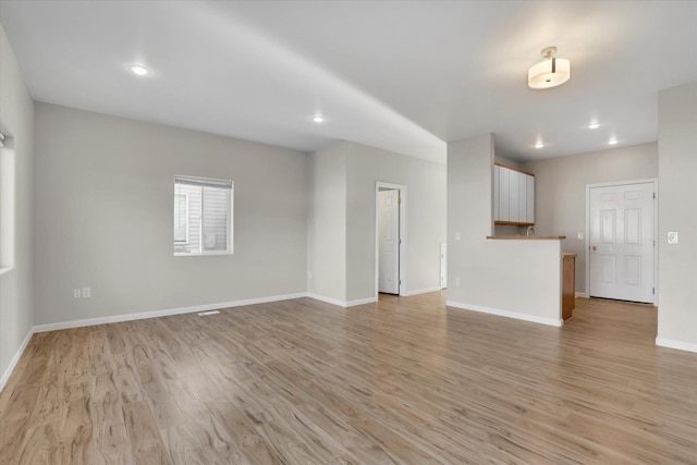 unfurnished living room with light hardwood / wood-style flooring