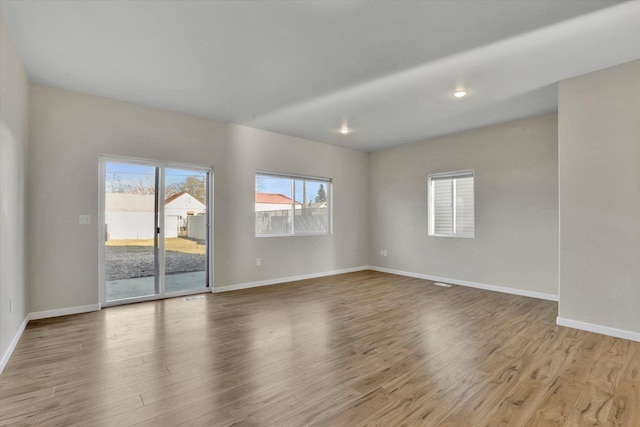 unfurnished room with light wood-type flooring