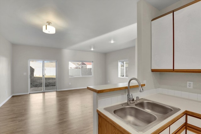 kitchen featuring sink, hardwood / wood-style flooring, and kitchen peninsula