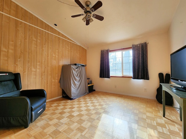 living area featuring light parquet flooring, lofted ceiling, and wood walls