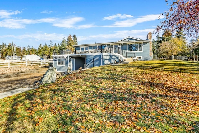 back of house featuring a yard