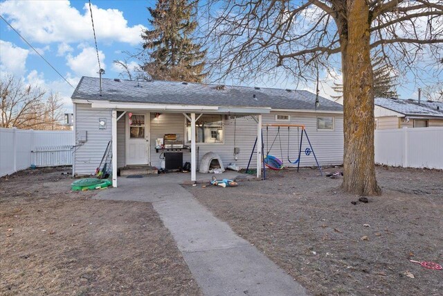 view of yard featuring a playground and an outbuilding