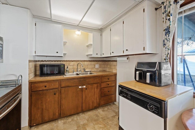 kitchen with white cabinetry, dishwasher, sink, and decorative backsplash