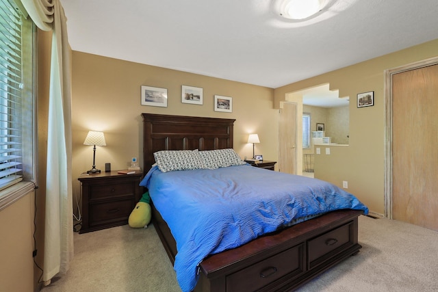 bedroom featuring light carpet